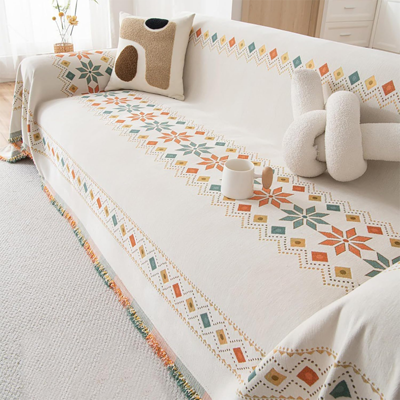 Housse réversible pour canapé bohème avec pompons – style chic et cosy